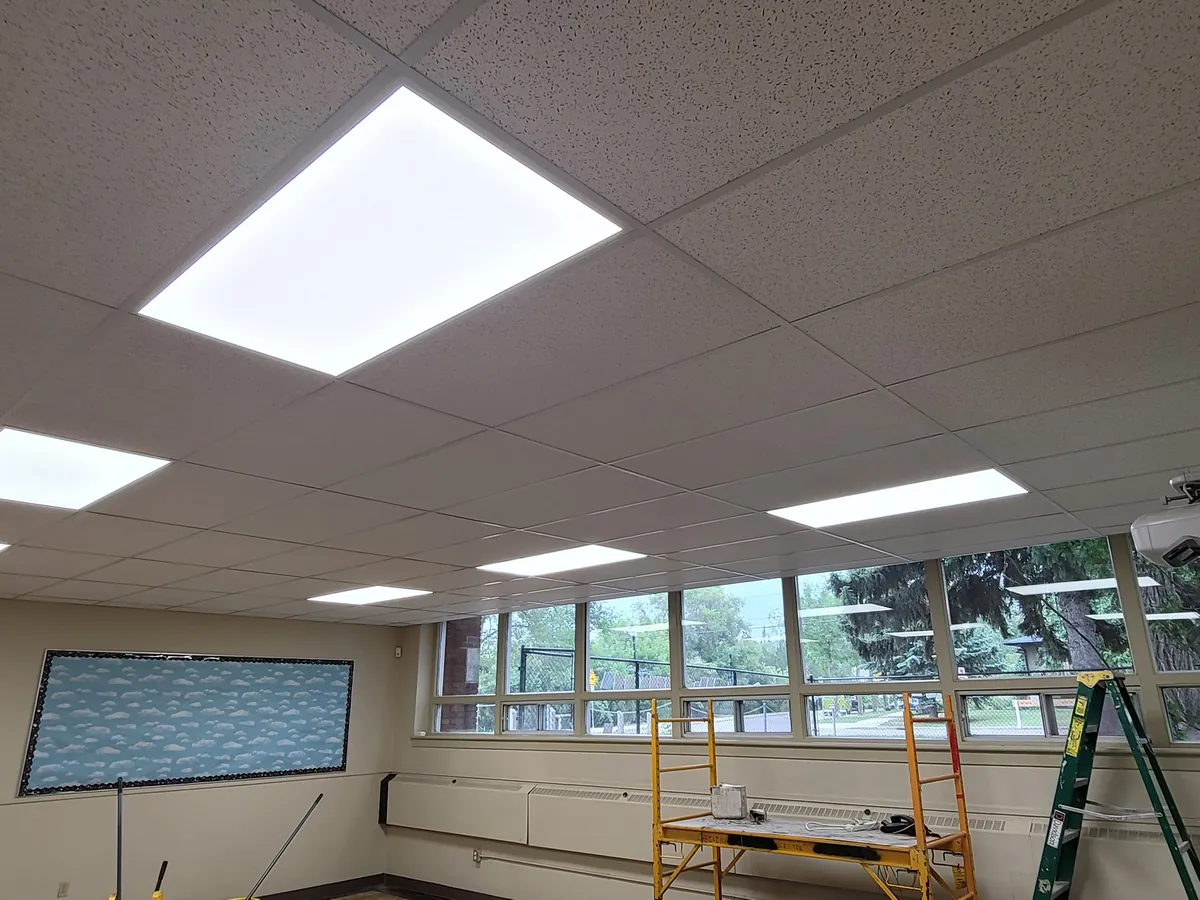 After: the same room with flat LED panels in the ceiling grid