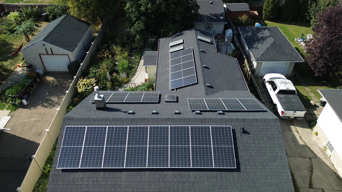 Vertical aerial of Dmitry's home showing the long west array and the middle dormer array
