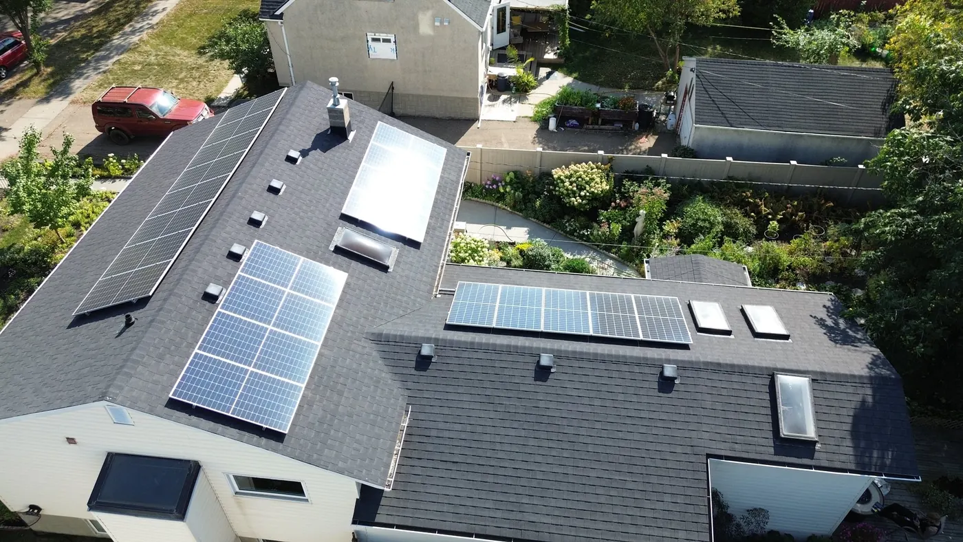 Aerial of Dmitry Naboka's 9.56 kW solar installation across four roof faces in west Edmonton
