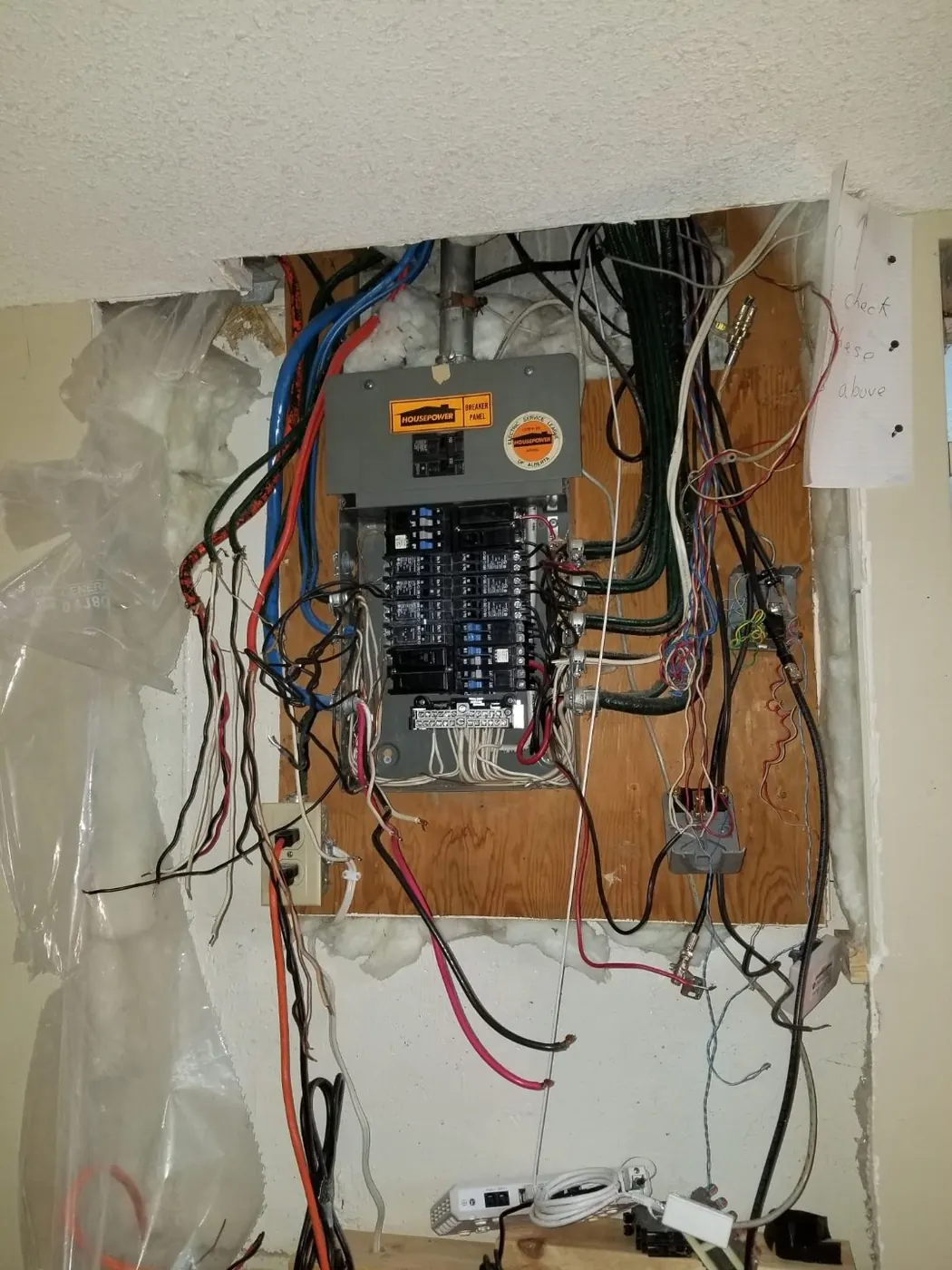 Before: old chaotic electrical panel before upgrade Edmonton