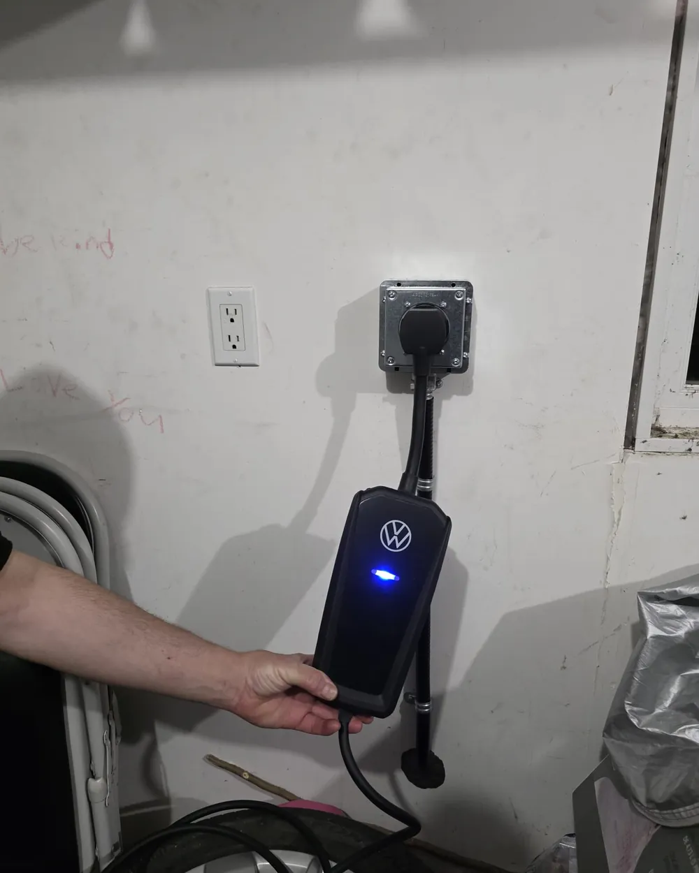 A Volkswagen portable EV charger plugged in and powered up after installation in Edmonton.
