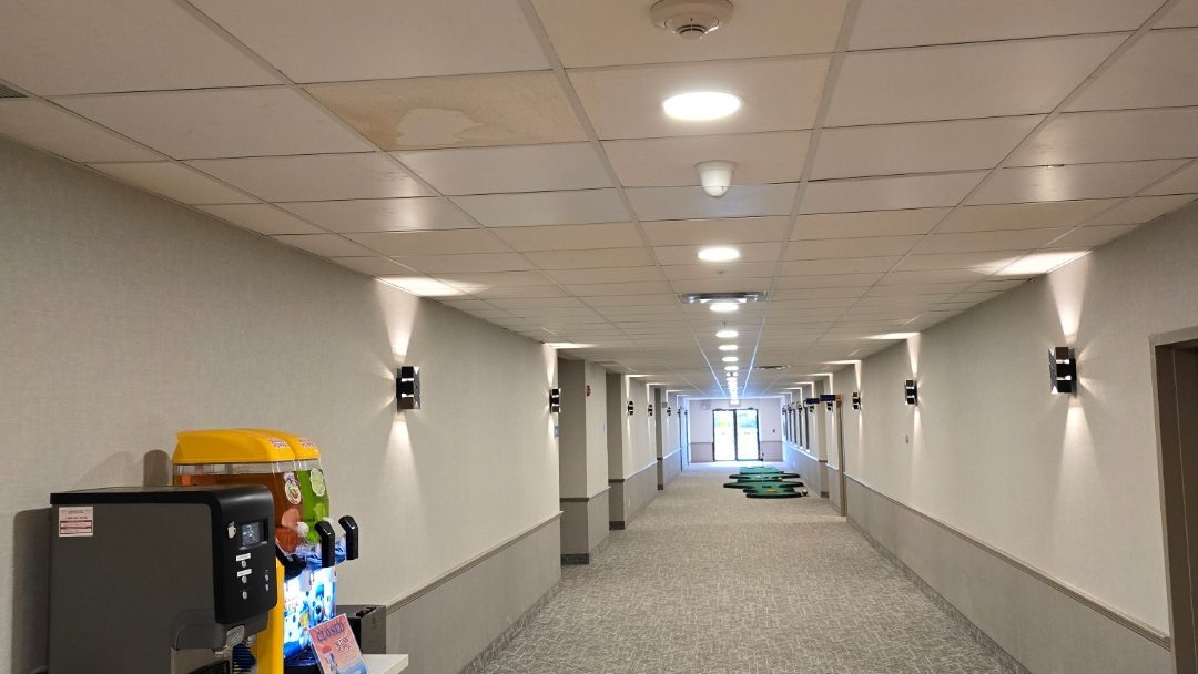 After: clean white LED light in the same Edmonton hotel hallway following the Raydn retrofit