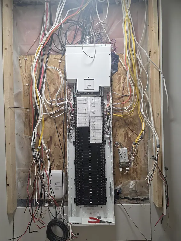 The new Leviton panel on the wall with the circuits brought in