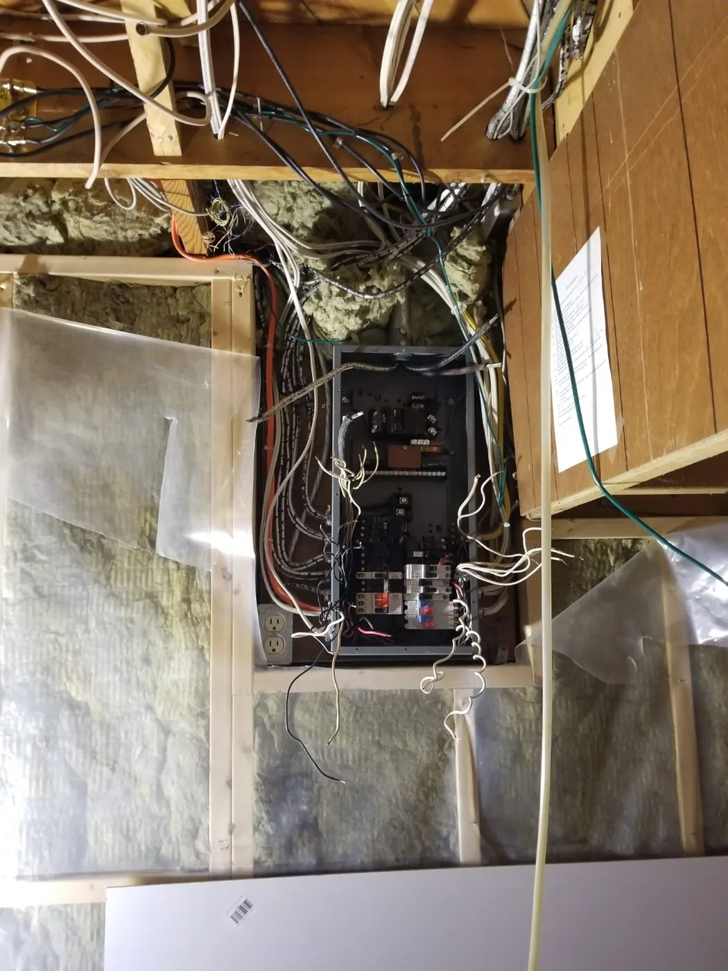 An older Edmonton electrical panel with the cover removed, showing crowded existing circuit wiring before an upgrade