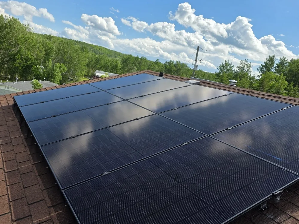 All-black rooftop solar array on an acreage home near Stony Plain with open rural exposure