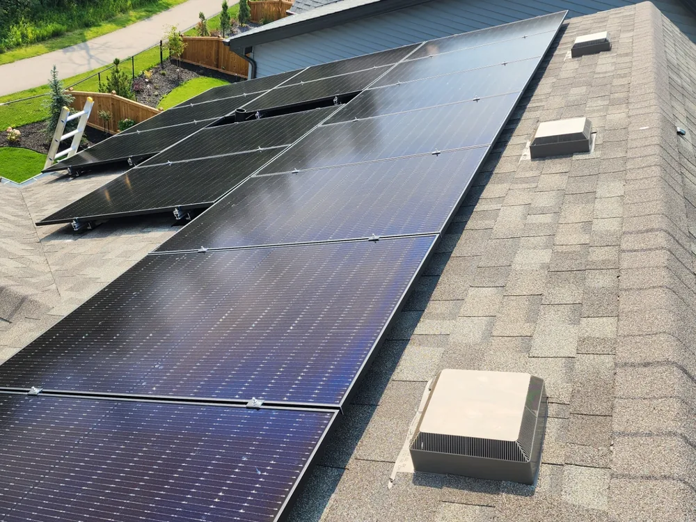 Long single-slope run of all-black LONGi solar panels on a Leduc home