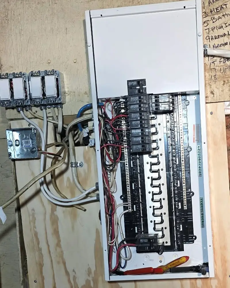 New panel with the cover off, every circuit landed on its own breaker