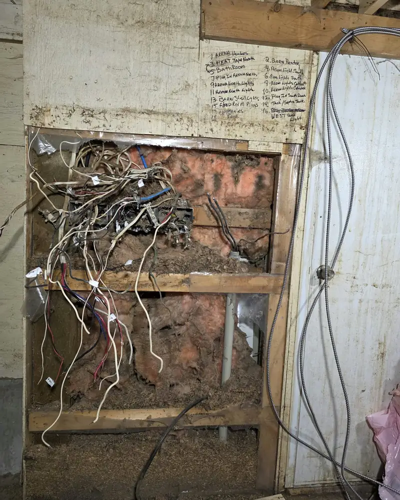 The old panel removed, with the circuits hanging out of the wall ready to be traced