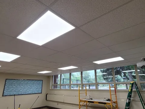 The same room with flat LED panels in the ceiling grid