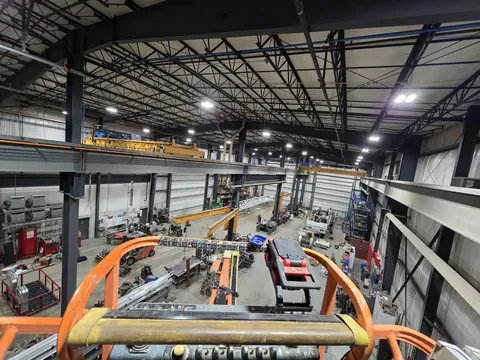LED high bays over an overhead crane in a fabrication shop