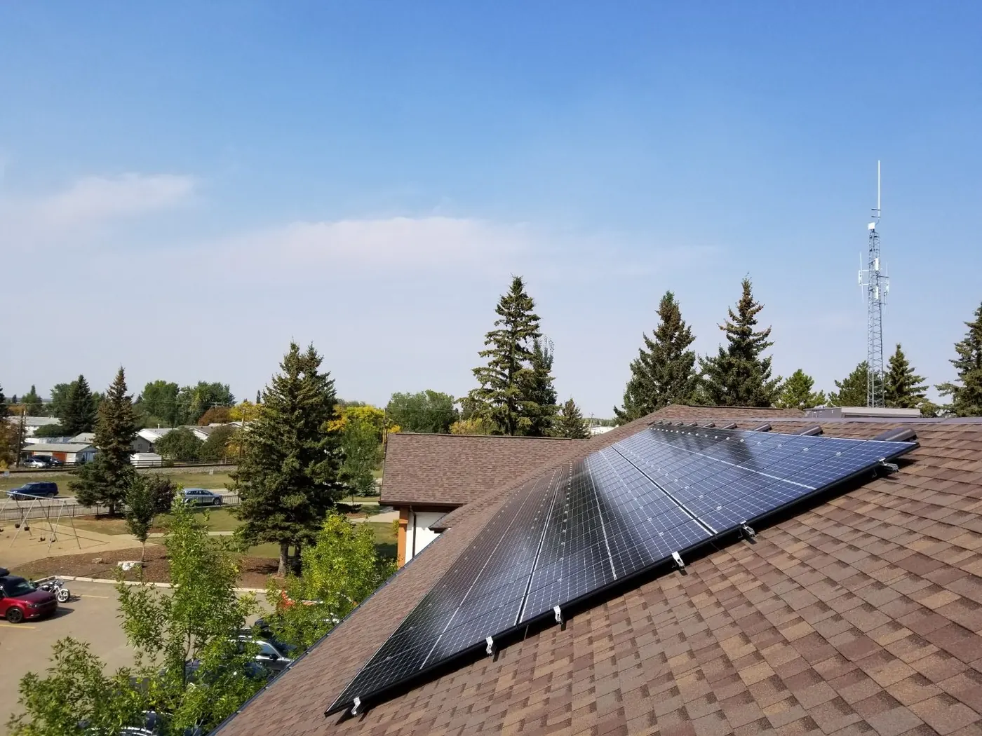 Solar panels installed on brown shingle roof aerial view Alberta 2018