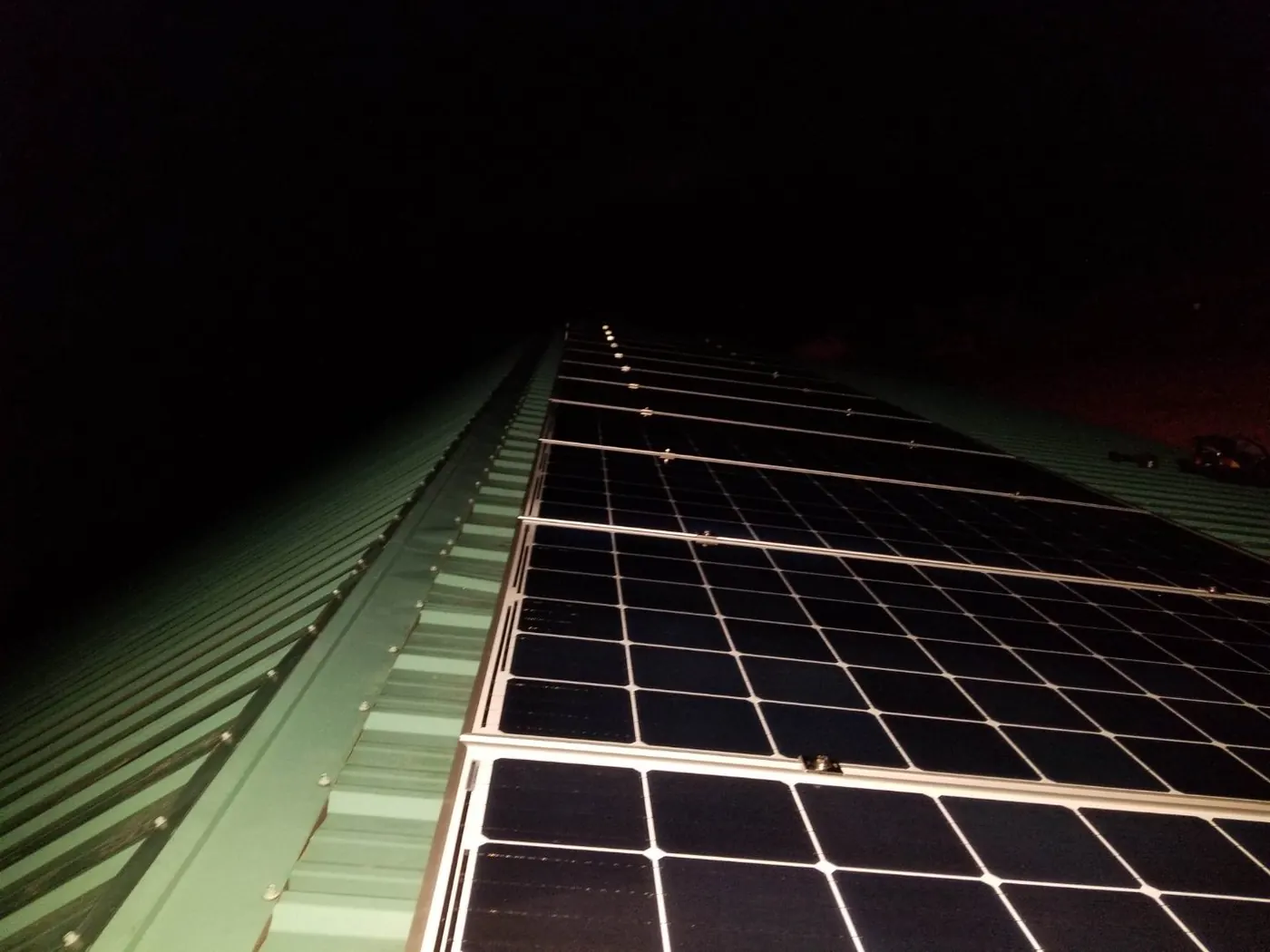 Solar panels on metal barn roof at night rural Alberta