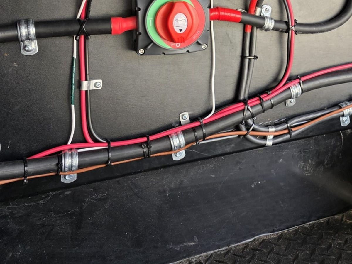Wire tags and silver witness marks on lugs in an RV electrical install
