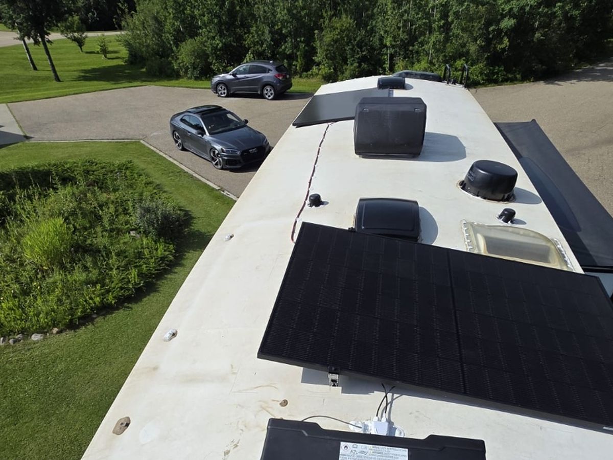 Two JA Solar modules mounted on an RV roof with the bonding path visible